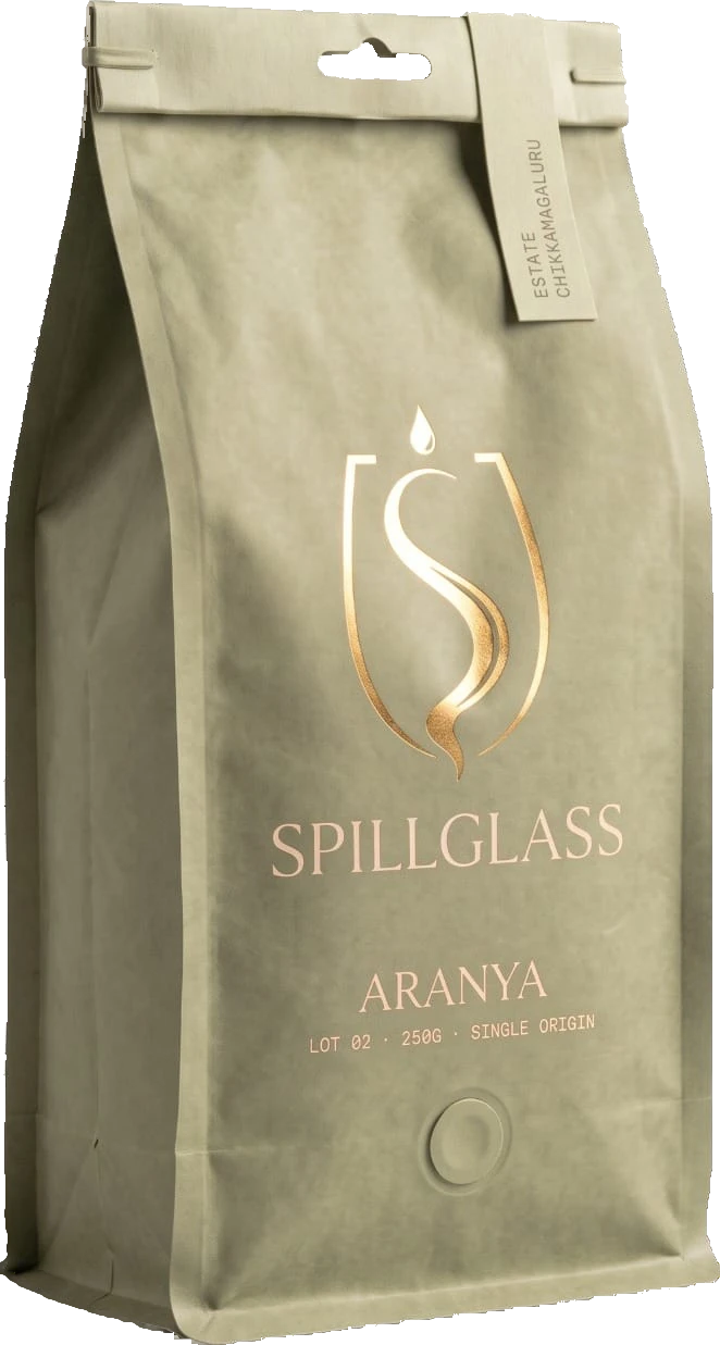 The SPILLGLASS Aranya pack, sage green with a gold chalice mark.